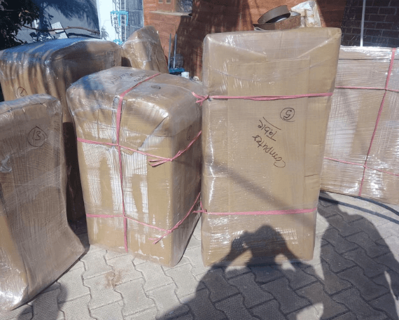 Gati Relocation team discussing move planning and organizing household goods before relocation